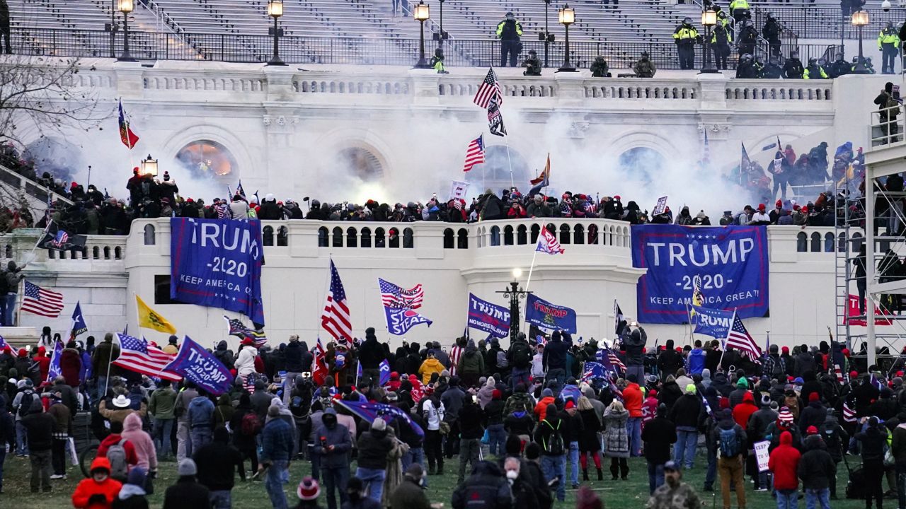 Insurrectionists loyal to President Donald Trump breach the Capitol in Washington, Jan. 6, 2021. The founder of the Hawaii Proud Boys chapter, Nicholas Ochs, and Nicholas DeCarlo, of Fort Worth, Texas, have been sentenced to four years in prison for their roles in the riot. (AP Photo/John Minchillo, File)