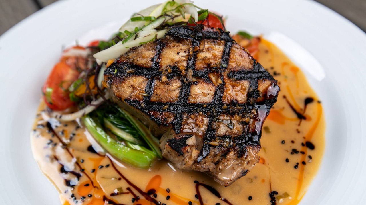 The Fire Grilled HaYn Catch with Kanaka Butter Sauce, lomi salmon, oyster sauce choi sum and Kapakahi Fried Rice is part of the pre-fixe menu available at Moani Waikiki during Grand Lanai Restaurant Week. (Courtesy IMP/Craig Bixel)