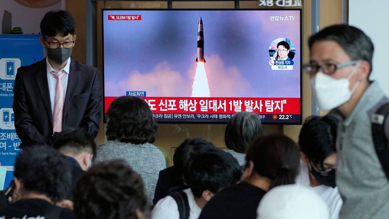 People watch a TV showing a file image of North Korea's missile launch during a news program at the Seoul Railway Station in Seoul, South Korea, Saturday, May 7, 2022. North Korea fired a suspected ballistic missile designed to be launched from a submarine on Saturday, South Korea's military said, apparently continuing a provocative streak in weapons demonstrations that may culminate with a nuclear test in the coming weeks or months. (AP Photo/Ahn Young-joon)