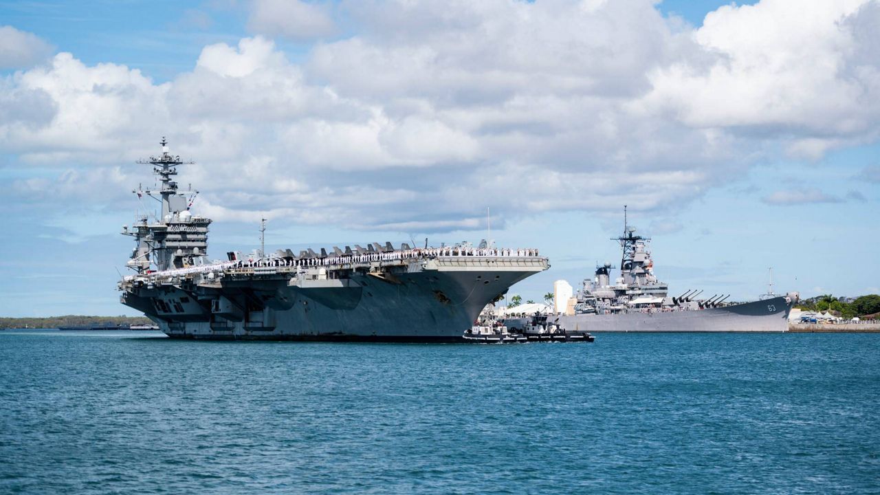Nimitz-class aircraft carrier USS Abraham Lincoln (CVN 72) passes the Battleship Missouri Memorial as it arrives at Joint Base Pearl Harbor-Hickam to participate in the Rim of the Pacific (RIMPAC) 2022, June 28. (U.S. Navy photo by Mass Communication Specialist 1st Class Devin M. Langer)