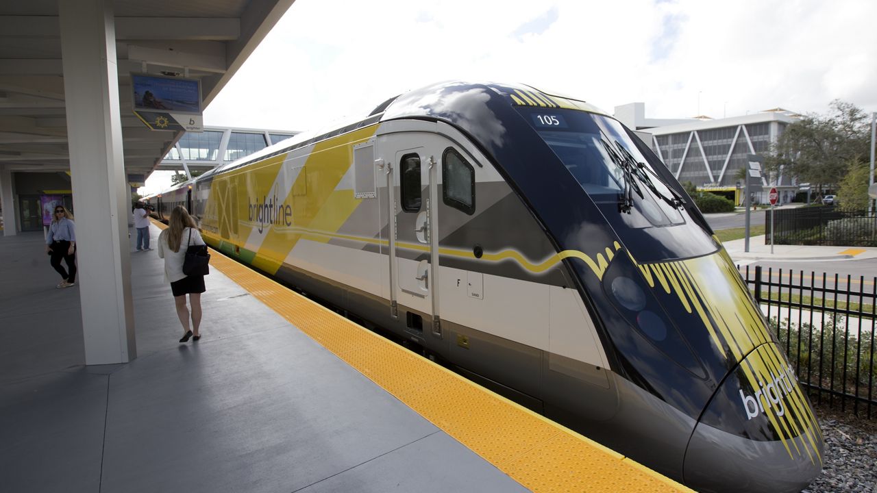 A Brightline train is shown at a station in Fort Lauderdale, Fla., on Jan. 11, 2018. A fast-tracked plan to build a high-speed passenger rail line between Las Vegas and the Los Angeles area is set to mark the start of construction. Brightline West and U.S. transportation secretary and other officials projecting that millions of ticket-buyers will be boarding trains by 2028. (AP Photo/Wilfredo Lee, File)