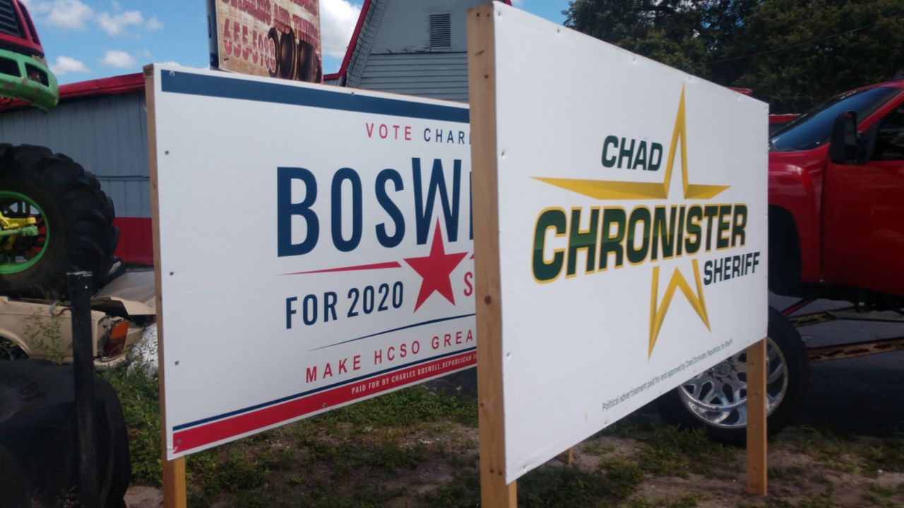 Chad Chronister sign blocks Charles Boswell sign in front of Hillsborough County business (Spectrum News)