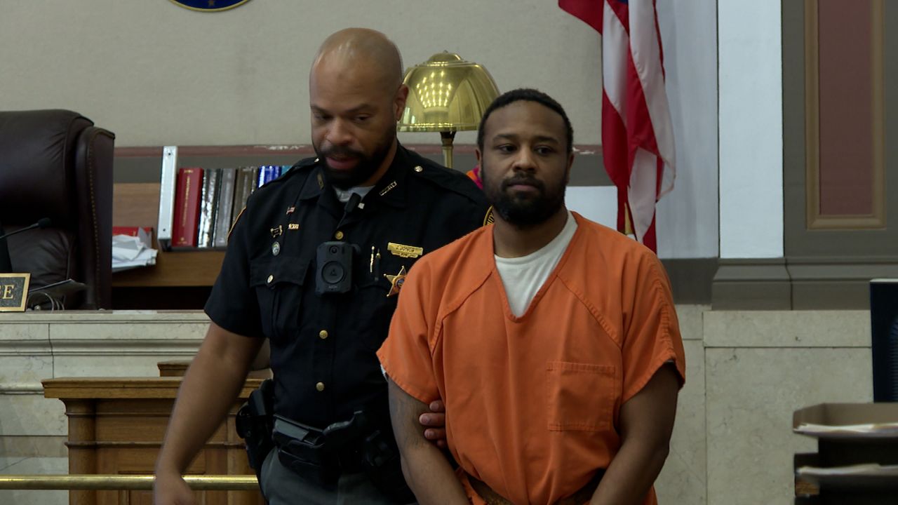 Driver accused in deputy killing faces judge one day after son’s death ruled justified. 