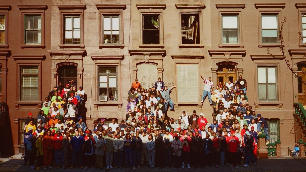 A photo of various hip-hop artists is pictured.