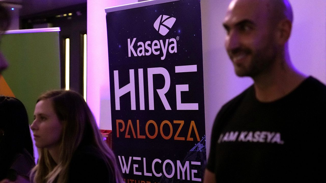 A sign for software company Kaseya is displayed Wednesday at the Venture Miami Tech Hiring Fair at Miami-Dade College Wolfson College in Miami. (AP Photo/Lynne Sladky)