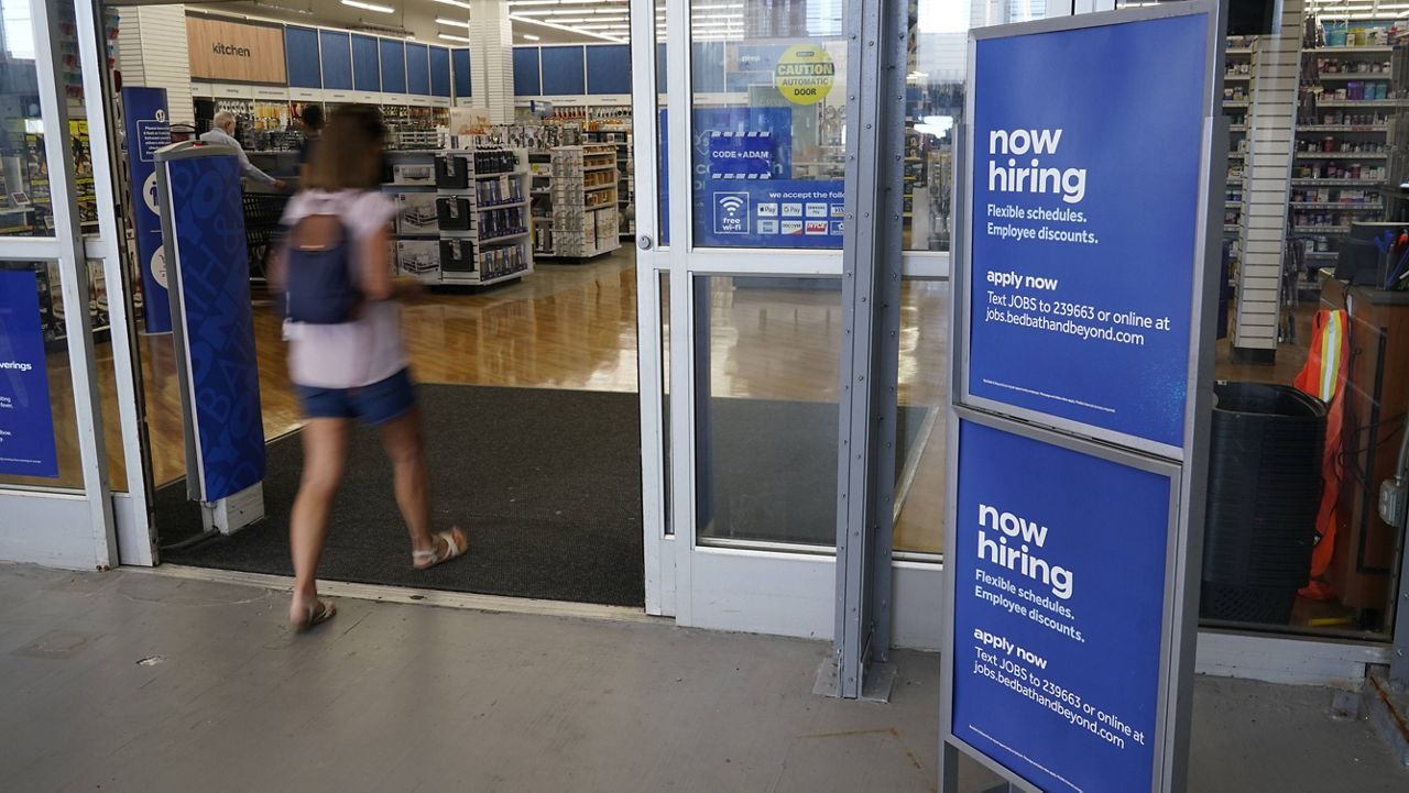 A sign looking to hire employees is displayed at the entrance to a Bed, Bath and Beyond store in Miami on Tuesday. (AP Photo/Marta Lavandier)