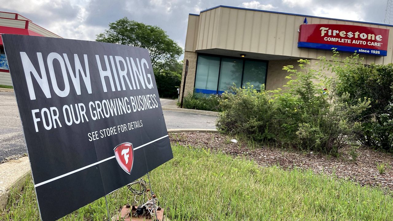 A hiring sign is displayed at Firestone Complete Auto Care store in Arlington Heights, Ill., on Wednesday. (AP Photo/Nam Y. Huh)