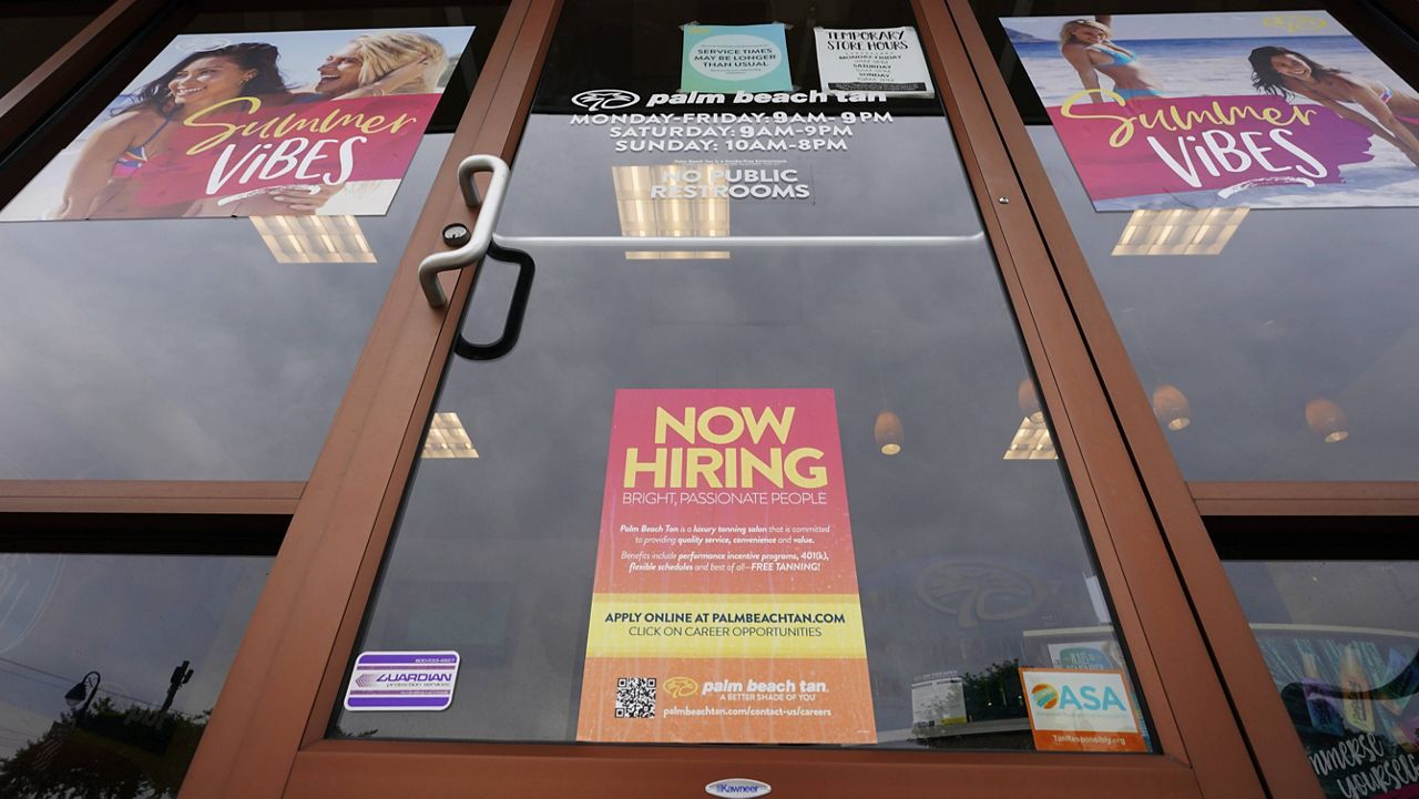 A hiring sign is seen at a business in Richmond, Va., on June 2. (AP Photo/Steve Helber)