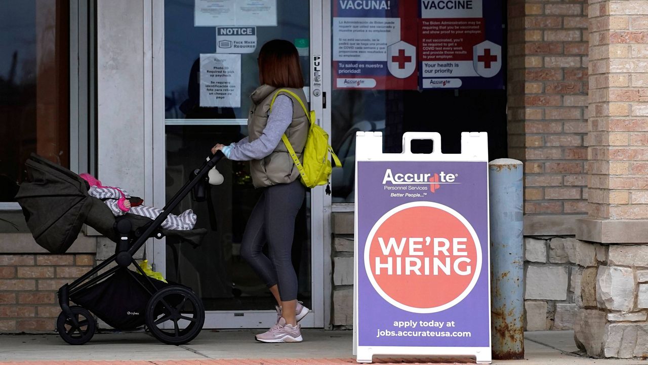A hiring sign is seen outside of Accurate Personnel office, an employment agency, in Buffalo Grove, Ill., on Dec. 3, 2021. (AP Photo/Nam Y. Huh)
