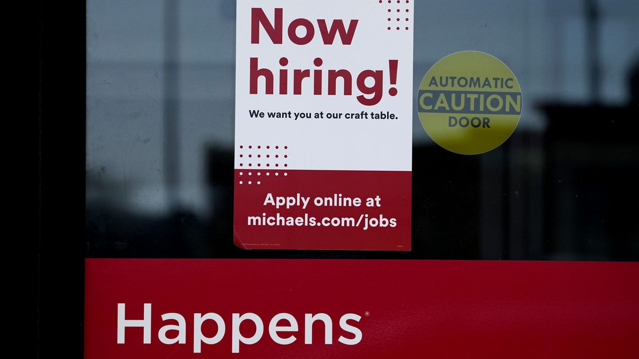 A hiring sign is displayed at a retail store in Downers Grove, Ill. (AP Photo/Nam Y. Huh)