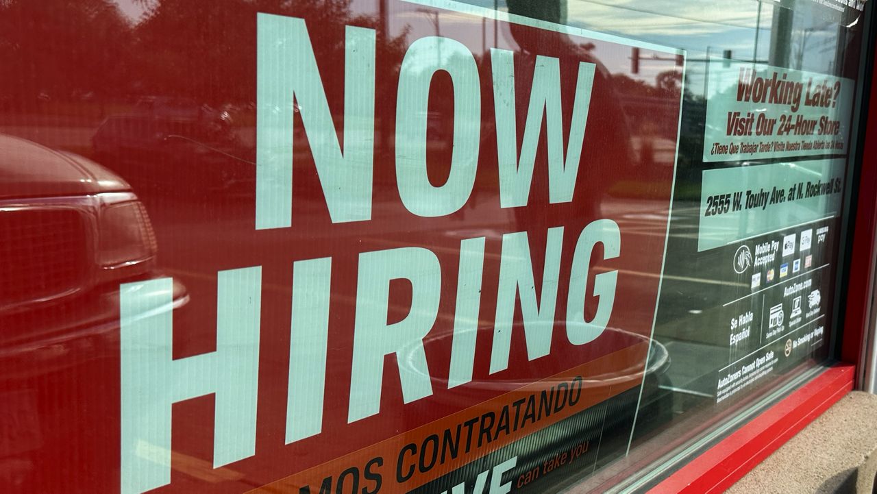 Hiring sign is displayed at a retail store in Wheeling, Ill., Sunday, Sept. 24, 2023. (AP Photo/Nam Y. Huh)