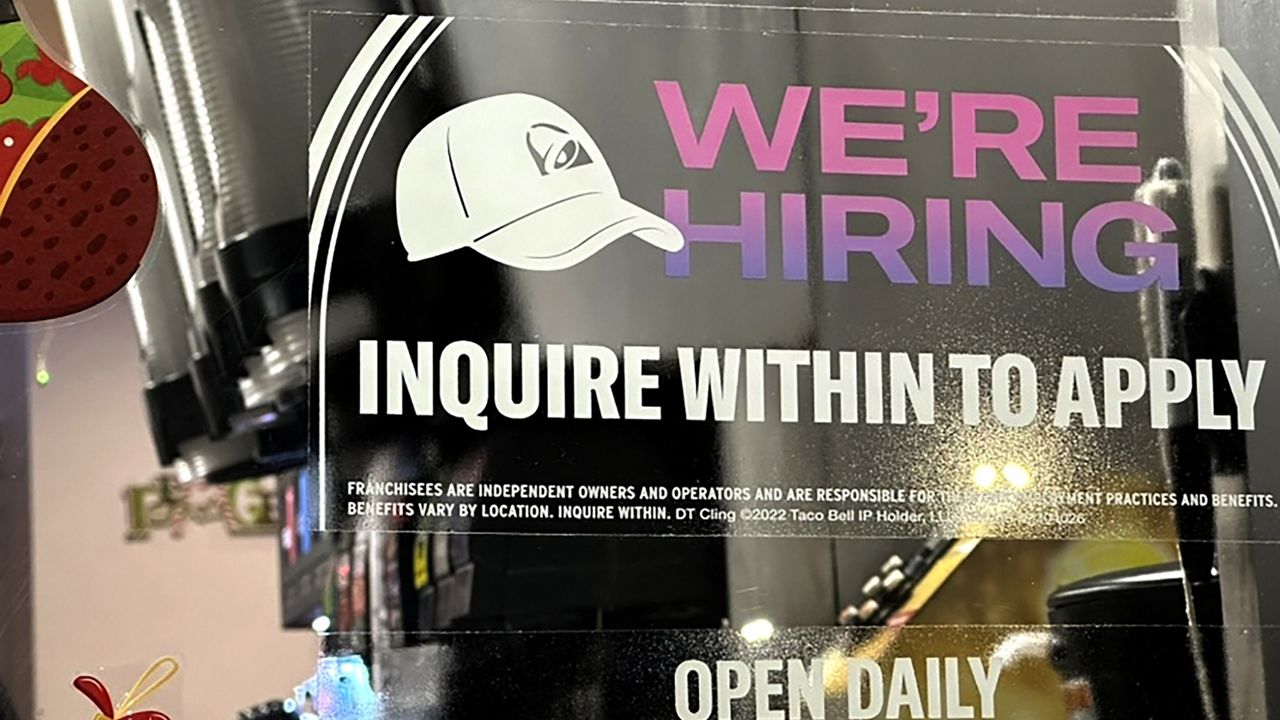 A hiring sign is displayed at a restaurant in Glenview, Ill., Tuesday, Dec.12, 2023. (AP Photo/Nam Y. Huh)