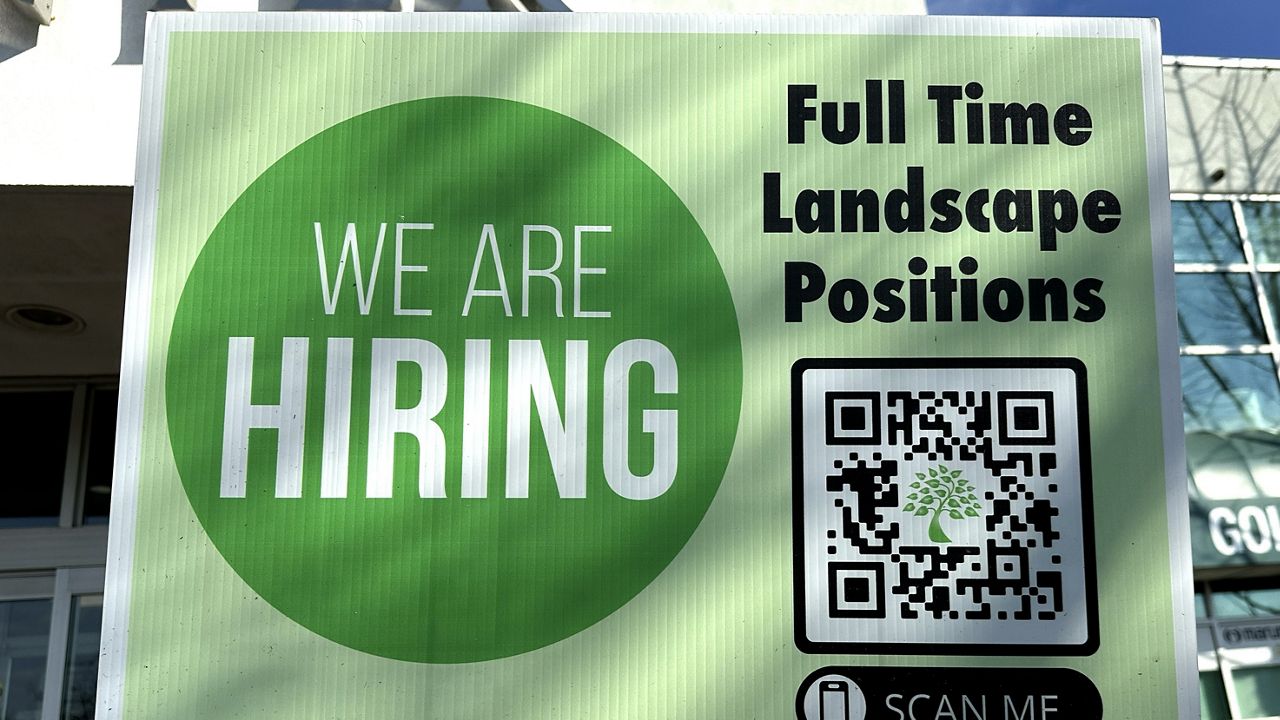 A hiring sign is displayed outside of Golf Center in Des Plaines, Ill., Thursday, Feb. 1, 2024. (AP Photo/Nam Y. Huh)