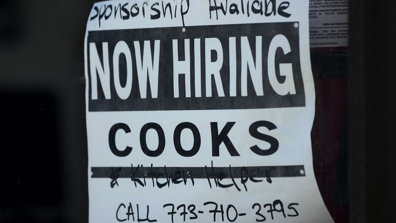 A hiring sign is displayed at a restaurant in Chicago, Monday, March 11, 2024. (AP Photo/Nam Y. Huh)
