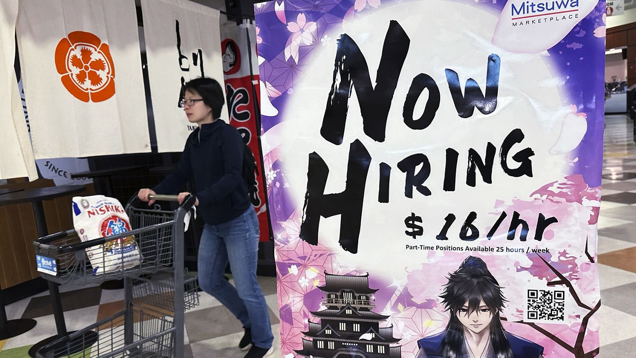 A hiring sign is displayed at a restaurant in Arlington Heights, Ill., Friday, June 28, 2024. (AP Photo/Nam Y. Huh)