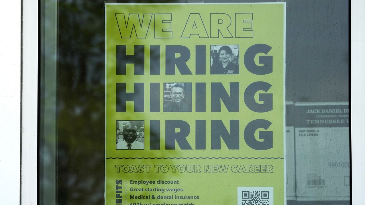 A hiring sign is displayed at a liquor store in Arlington Heights, Ill., May 21, 2024. (AP Photo/Nam Y. Huh, File)