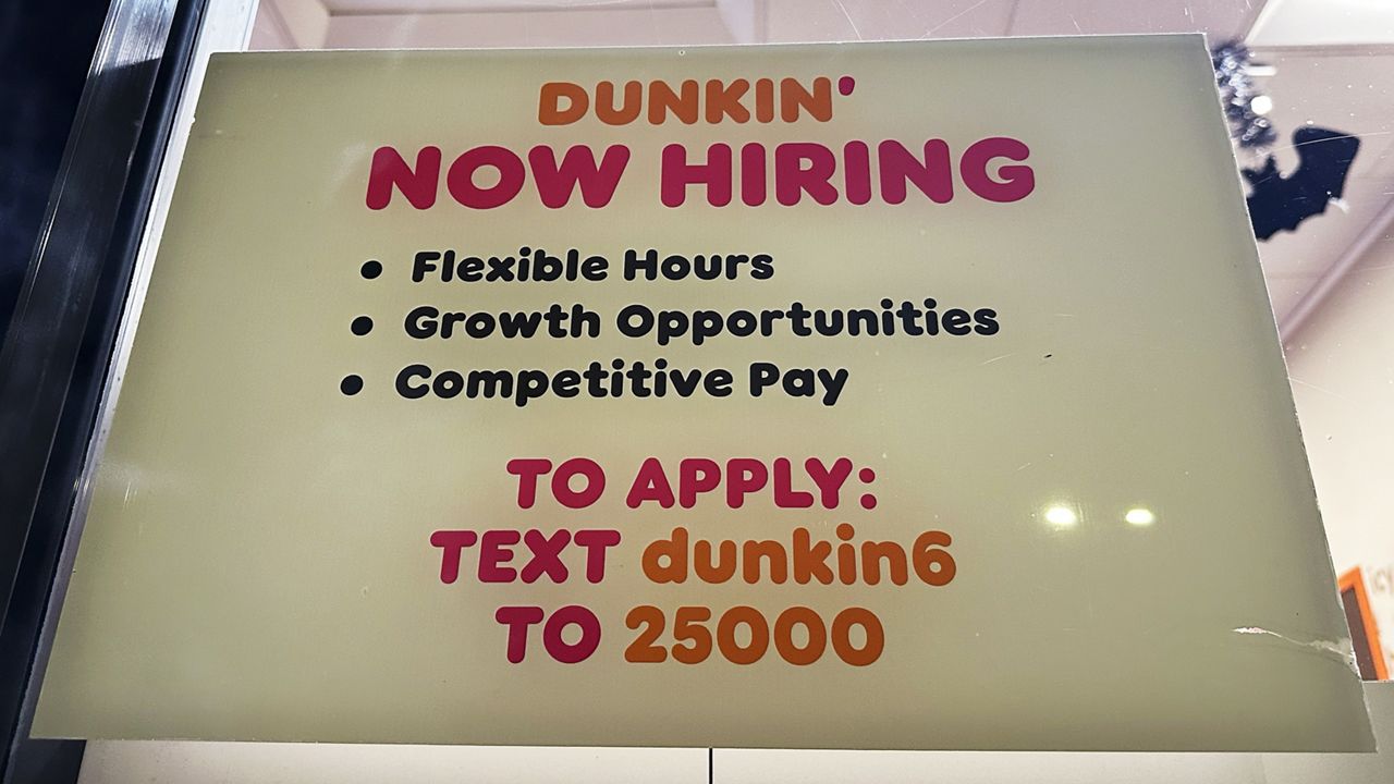 A hiring sign is displayed at a Dunkin' in Glenview, Ill., Tuesday, October. 1, 2024. (AP Photo/Nam Y. Huh)