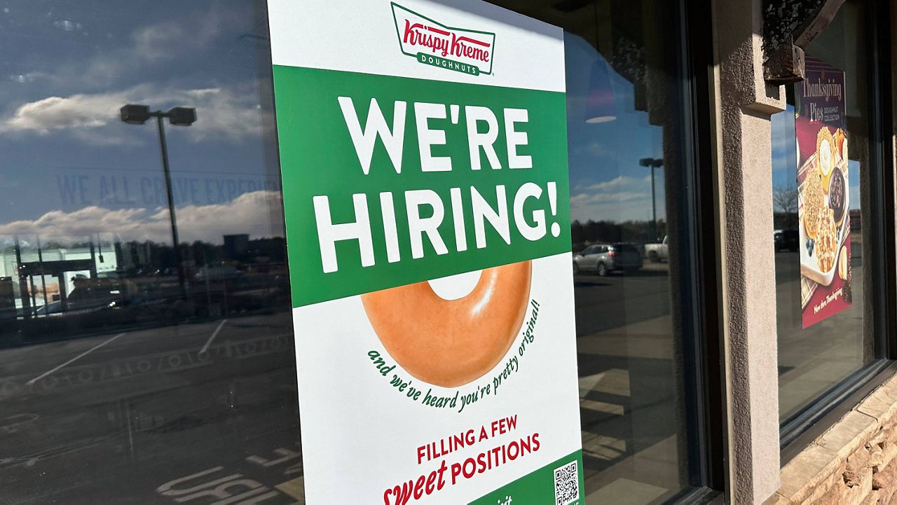 A hiring sign is displayed in the window of a Krispy Kreme donut shop on Nov. 19, 2024, in Lone Tree, Colo. (AP Photo/David Zalubowski, File)