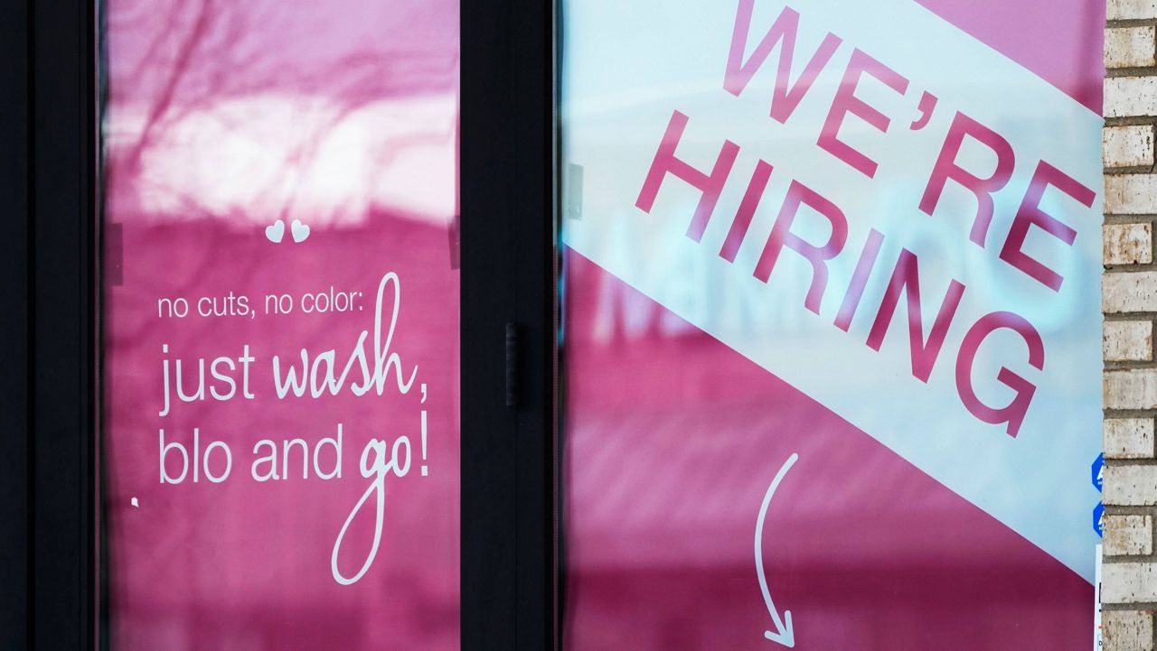 A hiring sign is displayed at a hair salon in Vernon Hills, Ill., March 28, 2023. (AP Photo/Nam Y. Huh, File)