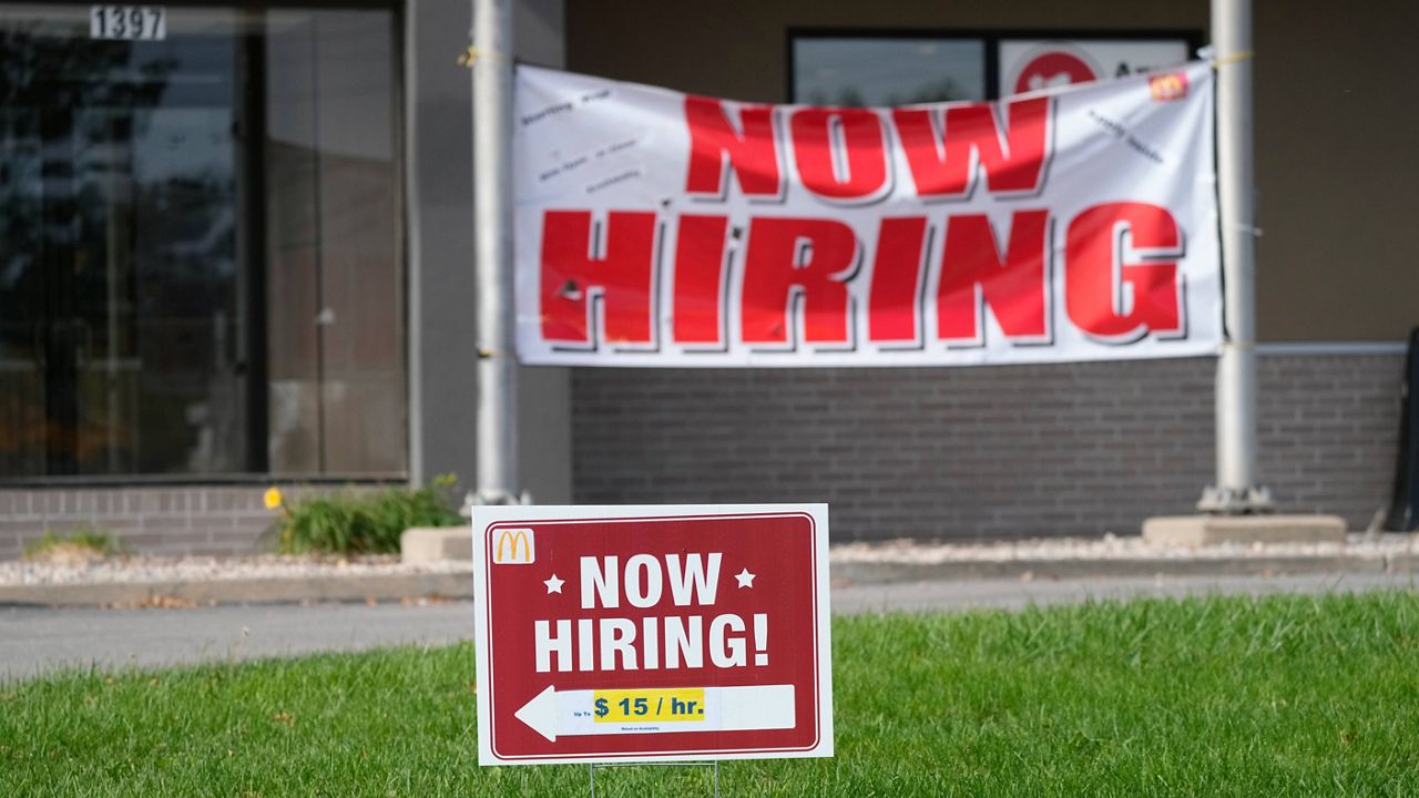 Now-hiring signs stand in front of a McDonald's in Seward, Neb., on Oct. 9. (AP Photo/David Zalubowski)
