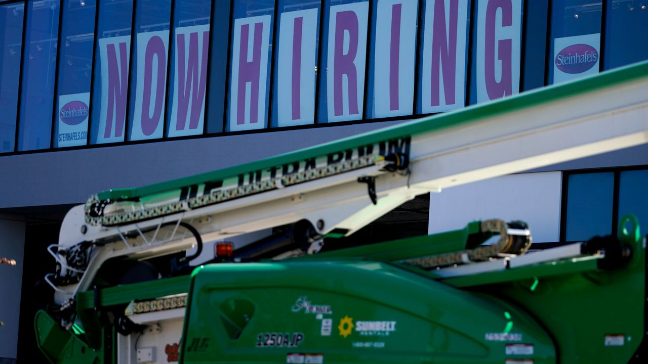 A hiring sign is displayed at a furniture store window in Downers Grove, Ill., on Sept. 17, 2021. (AP Photo/Nam Y. Huh, File)