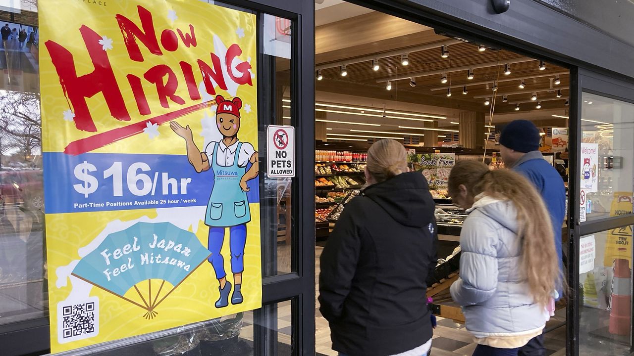 A hiring sign is displayed at a grocery store in Arlington Heights, Ill., on Jan. 13. (AP Photo/Nam Y. Huh)