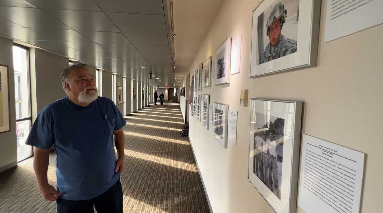 Carlos Figueroa looks at pictures of his family members.