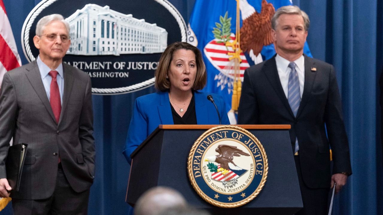 Deputy Attorney General Lisa Monaco, flanked by Attorney General Merrick Garland, left, and FBI Director Christopher Wray, speaks during a news conference Thursday at the Department of Justice in Washington. (AP Photo/Jose Luis Magana)