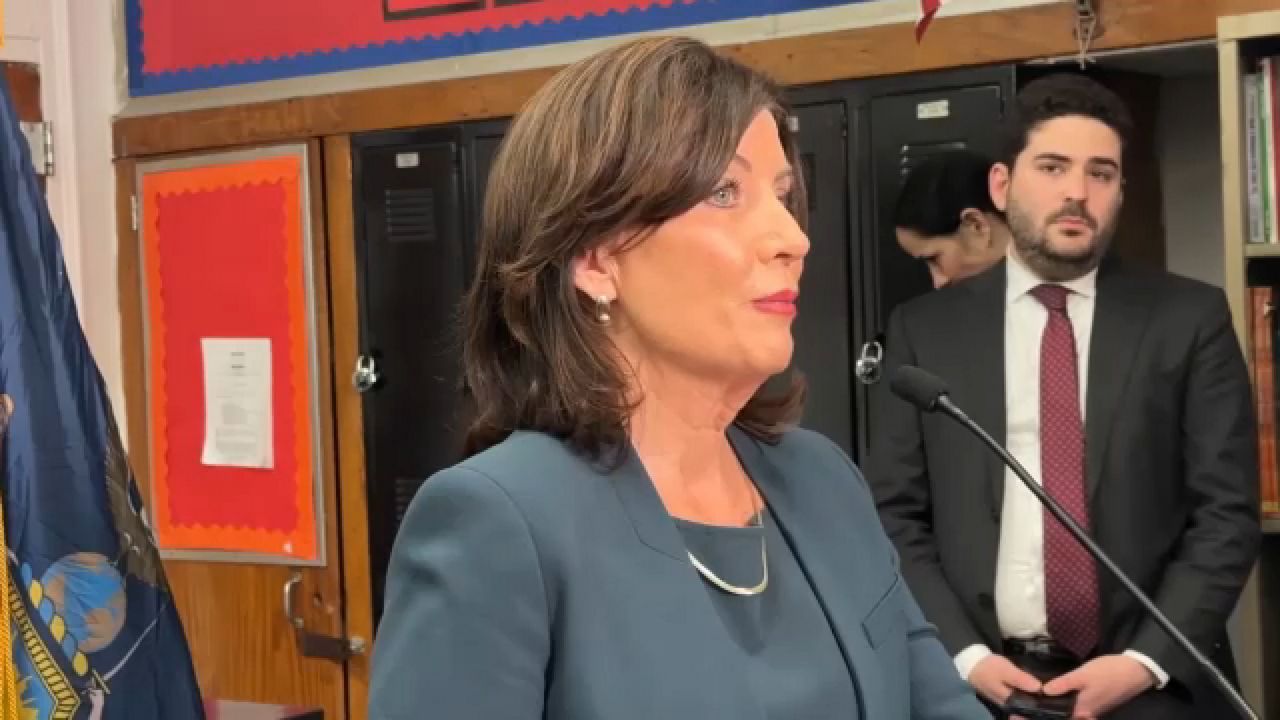 Gov. Kathy Hochul and Avi Small together at a press conference. (Spectrum News 1 Photo)