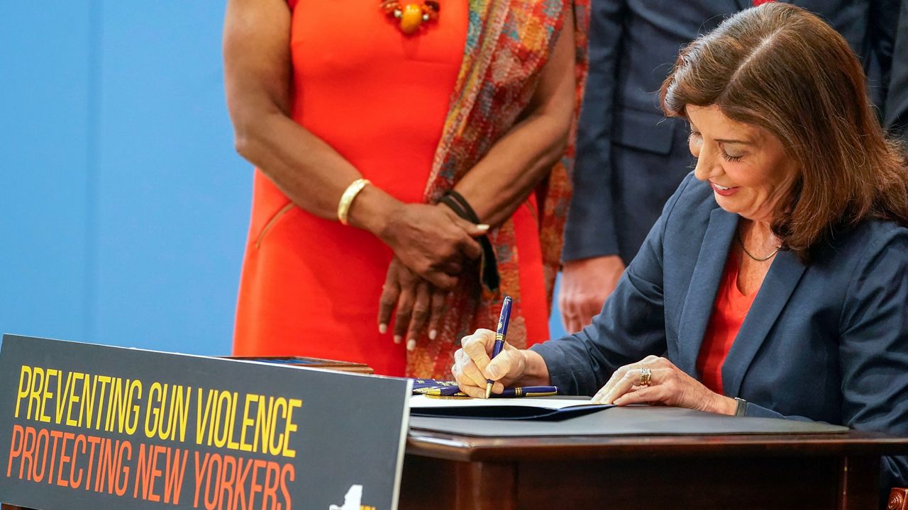 New York Gov. Kathy Hochul signs a package of bills to strengthen gun laws, June 6, 2022, in New York. The Supreme Court, Thursday, June 23, 2022, struck down a restrictive New York gun law in a major ruling for gun rights. (AP Photo/Mary Altaffer, File)