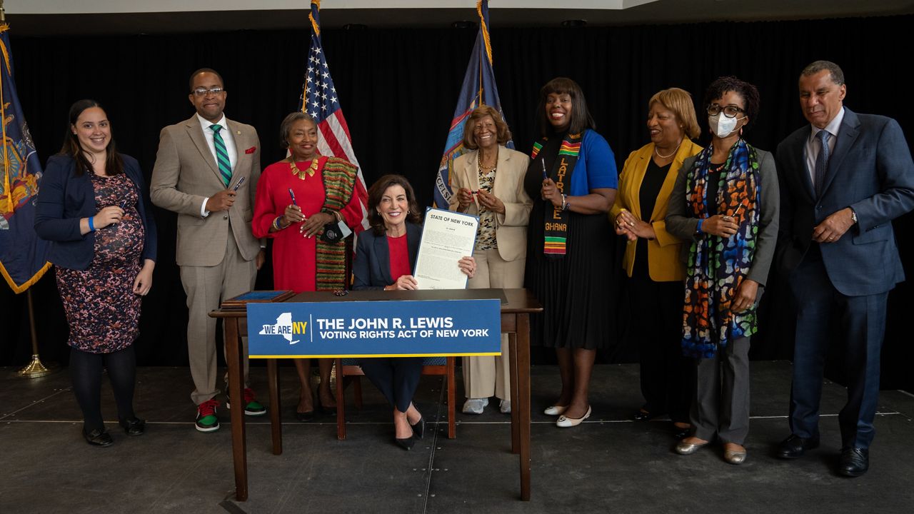 Gov. Kathy Hochul signs the John Lewis Voting Rights Act into law Monday.