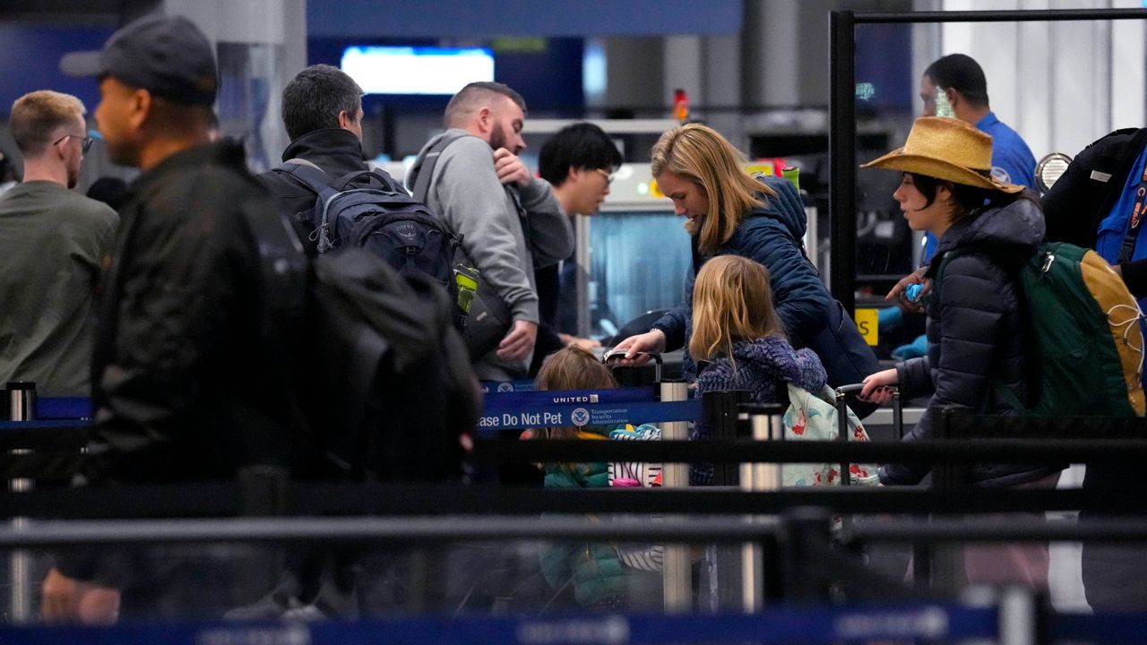 Travelers wait to go through a security checkpoint at O'Hare International Airport in Chicago on Thursday. (AP Photo/Nam Y. Huh)