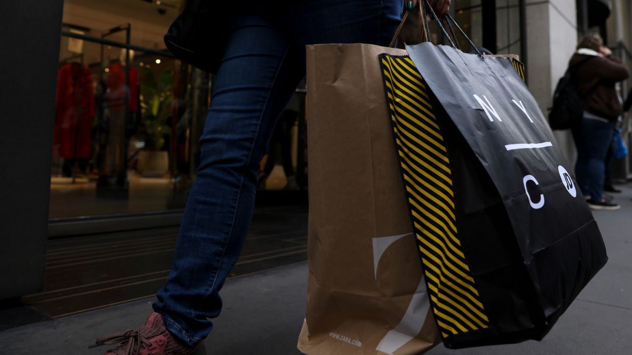A shopper carries bags down Fifth Avenue on Black Friday, Nov. 25, in New York. (AP Photo/Julia Nikhinson, File)