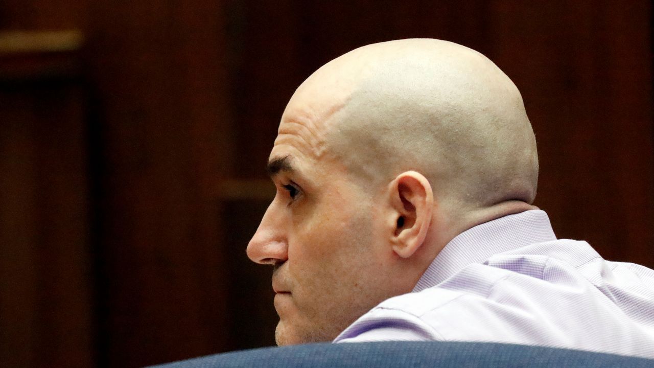 Michael Gargiulo listens as his guilty verdicts on all counts are read in Los Angeles Superior Court Thursday, Aug. 15, 2019. A jury found Gargiulo guilty of fatally stabbing two women and attempting to kill a third in their Southern California homes. Gargiulo, is also awaiting trial for a similar killing in Illinois in 1993. (Al Seib/Los Angeles Times via AP, Pool)