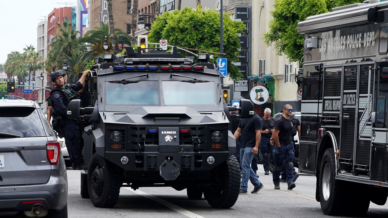 Los Angeles Police Department Special Weapons and Tactics (SWAT) team members leave following an hours-long standoff after a man fired a gun inside his apartment before barricading himself inside, Sunday, July 31, 2022, in the Hollywood district of Los Angeles. (AP Photo/Damian Dovarganes, File)