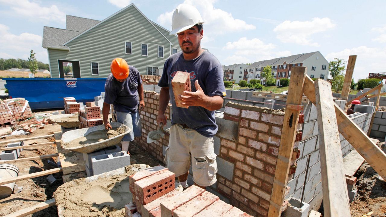 In this July 14, 2010 photo, a mason lays brick on a foundation for a new home in Richmond, Va. (AP Photo/Steve Helber)