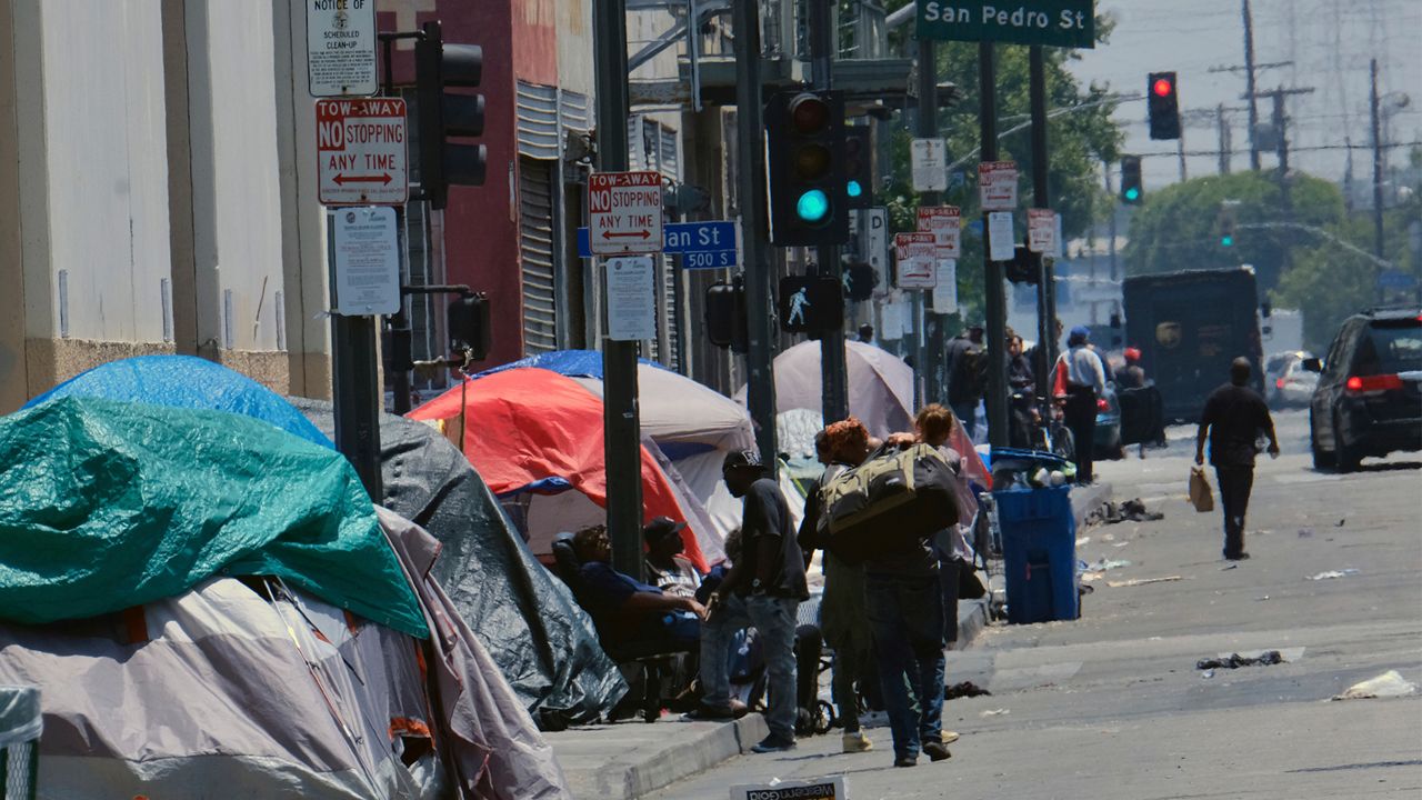 In this May 30, 2019, file photo, tents housing homeless line a street in downtown Los Angeles. (AP Photo/Richard Vogel)