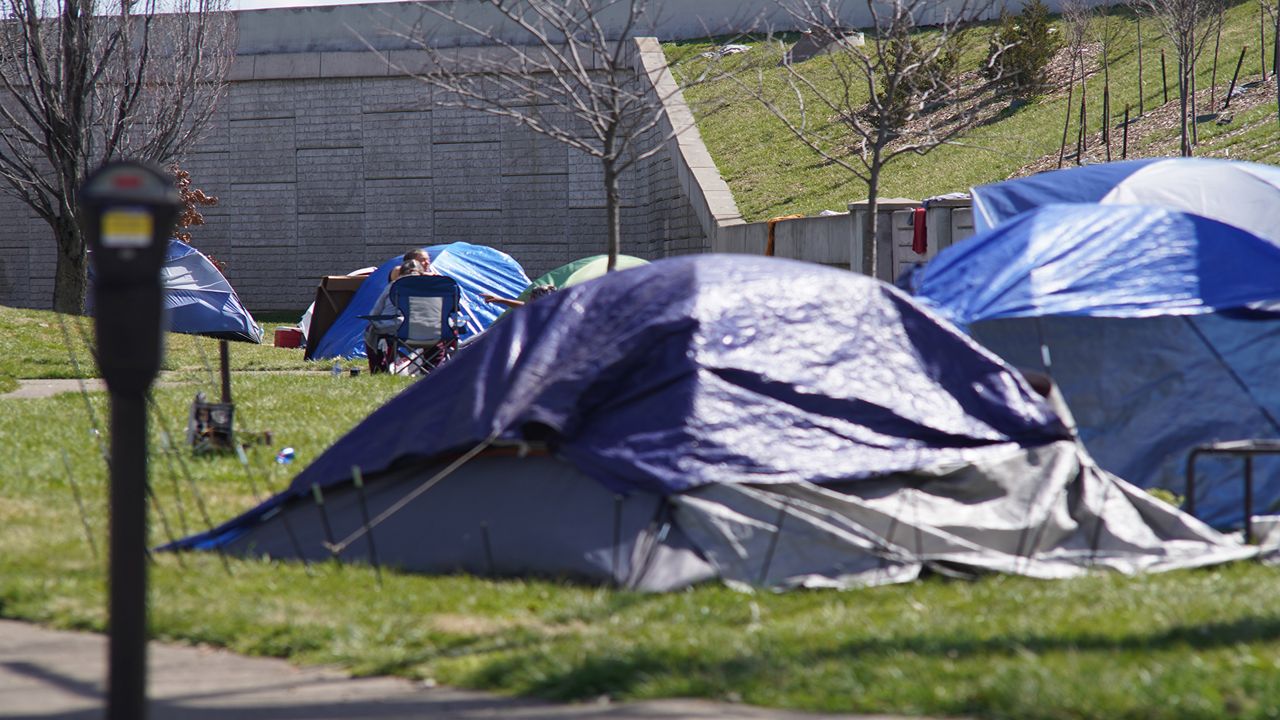 tents line a street in louisville where homeless people are sheltered