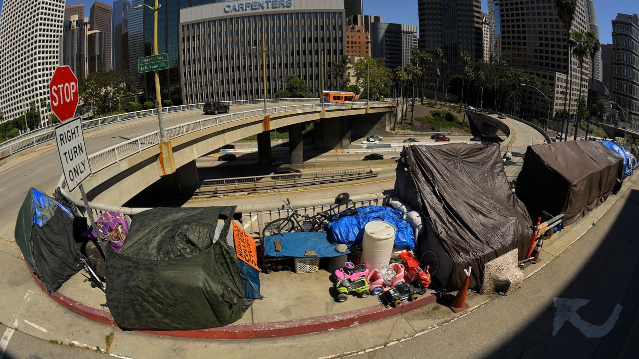 A homeless encampment is seen at the corner of Wilshire Boulevard and Beaudry amid the coronavirus outbreak, Thursday, May 21, 2020, in downtown Los Angeles.  (AP Photo/Mark J. Terrill)