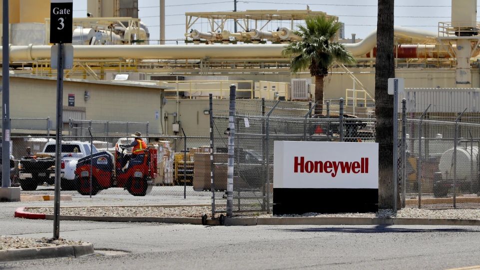 Construction workers pave a parking lot at a Honeywell plant on April 4, 2020, in Phoenix. (AP Photo/Matt York, File)