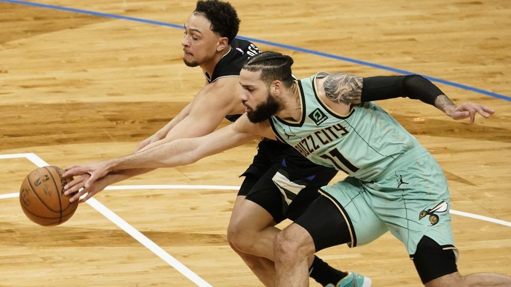 Milwaukee Bucks' Bryn Forbes and Charlotte Hornets' Cody Martin go after a loose ball during the first half of an NBA basketball game Friday, April 9, 2021, in Milwaukee. (AP Photo/Morry Gash)