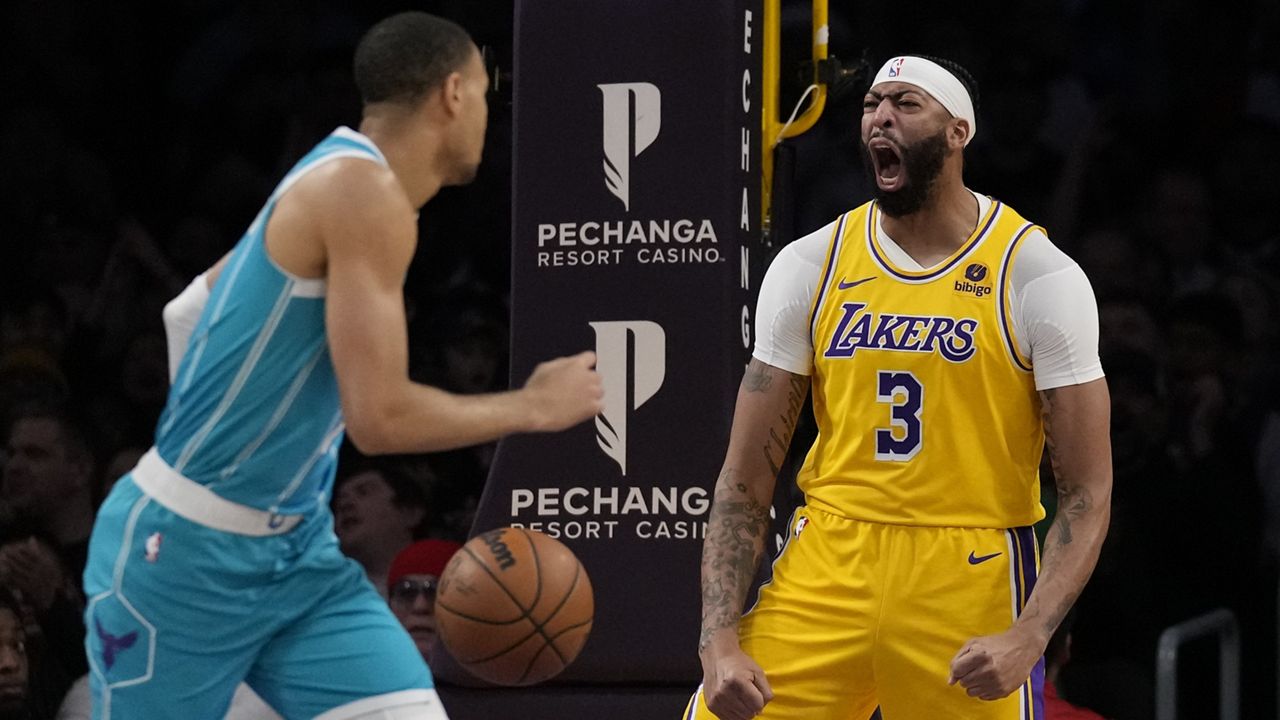 Los Angeles Lakers forward Anthony Davis (3) reacts after a dunk against the Charlotte Hornets during the first half of an NBA basketball game in Los Angeles, Thursday, Dec. 28, 2023. (AP Photo/Ashley Landis)