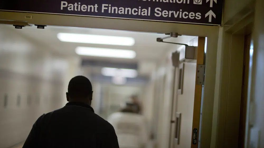 A sign points visitors toward the financial services department at a hospital, Friday, Jan. 24, 2014. Medicaid coverage will end for millions of Americans in 2023, and that pushes many into unfamiliar territory: the health insurance marketplace. (AP Photo/David Goldman)