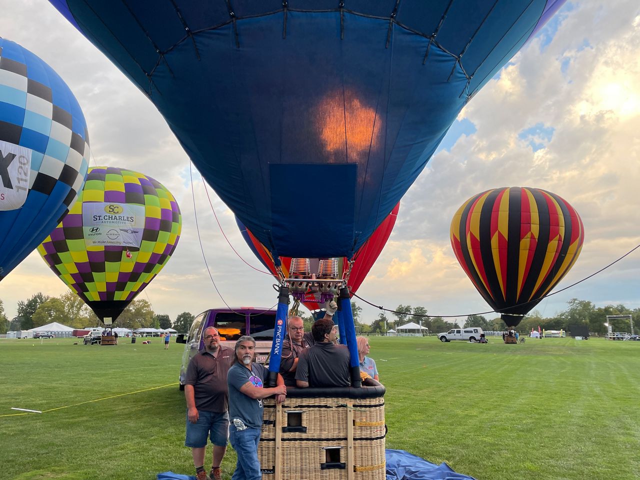 hot air balloon with fire lighting up balloon envelope