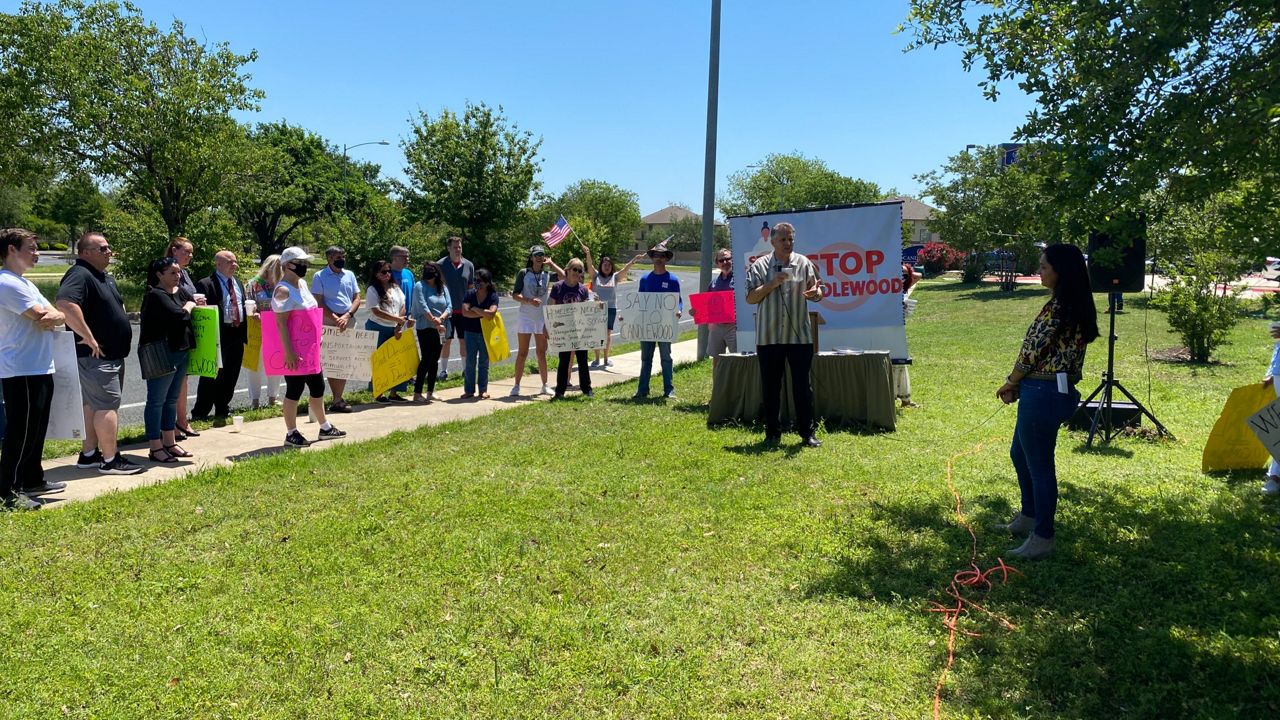 Business owners and community members protest the City of Austin's plans to purchase the Candlewood Suites property in northwest Austin in this image from April 25, 2021. (Spectrum News 1/Niki Griswold)
