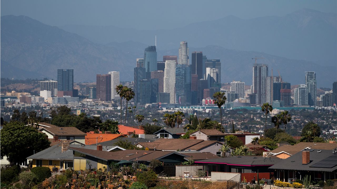 Homes sit on a hilltop with a view of the downtown Los Angeles skyline Thursday, June 10, 2021, in Los Angeles. (AP Photo/Jae C. Hong)