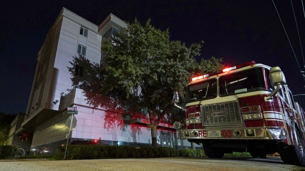 A firetruck is positioned outside the Chinese Consulate Wednesday, July 22, 2020, in Houston. Authorities responded to reports of a fire at the consulate. Witnesses said that people were burning paper in what appeared to be trash cans, according to police. China says the U.S. has ordered it to close its consulate in Houston in what it called a provocation that violates international law. (AP Photo/David J. Phillip)