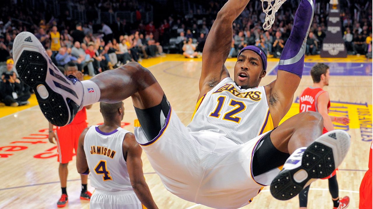 Los Angeles Lakers center Dwight Howard follows through on a dunk during the second half of their NBA basketball game against the Houston Rockets, Sunday, Nov. 18, 2012, in Los Angeles. The Lakers won 119-108. (AP Photo/Mark J. Terrill)