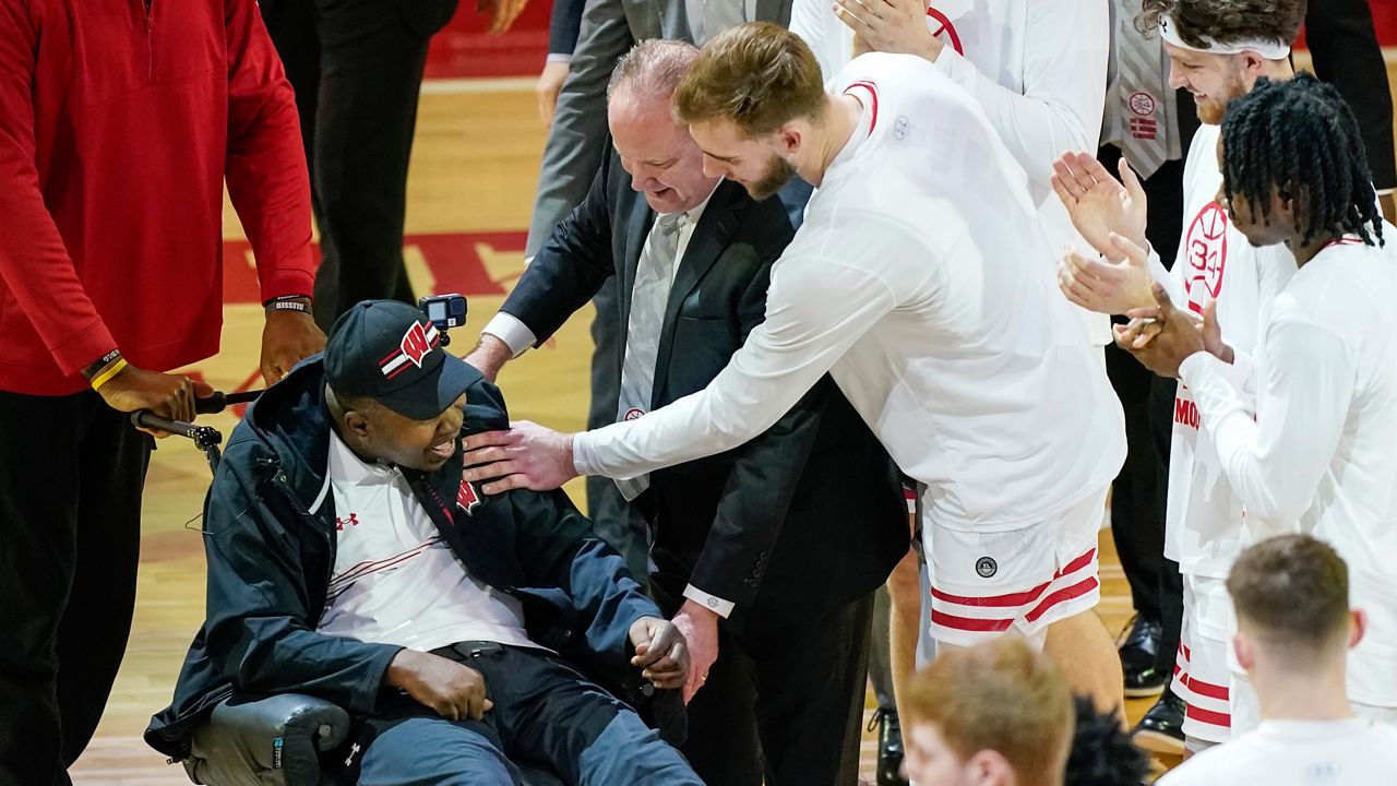 Former Wisconsin player and assistant coach Howard Moore is greeted by the Wisconsin team Saturday, March 2, 2024, in Madison, Wis