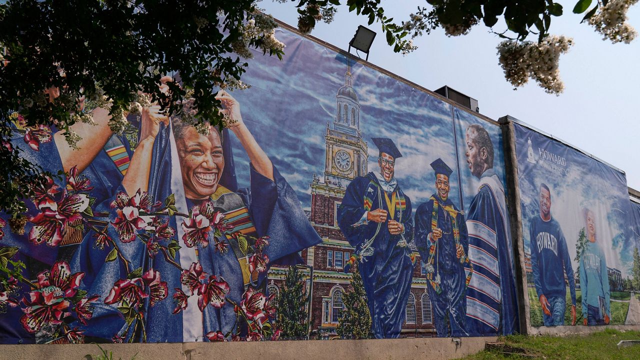 FILE - A graduation themed printed mural is seen on the Howard University campus, July 6, 2021, in Washington. (AP Photo/Jacquelyn Martin)
